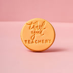 Round orange stamp with 'Thank you teachers' text on a pink background