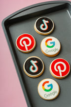 Cookies with social media platform logos on a baking tray