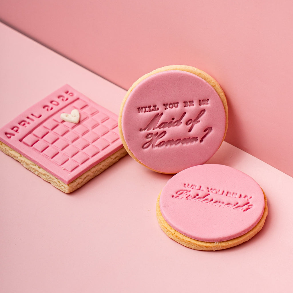Three pink cookies with text on a pink background