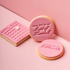 Three pink cookies with text on a pink background