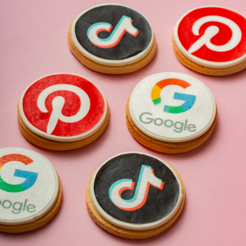 Cookies with social media and Google logos on a pink background